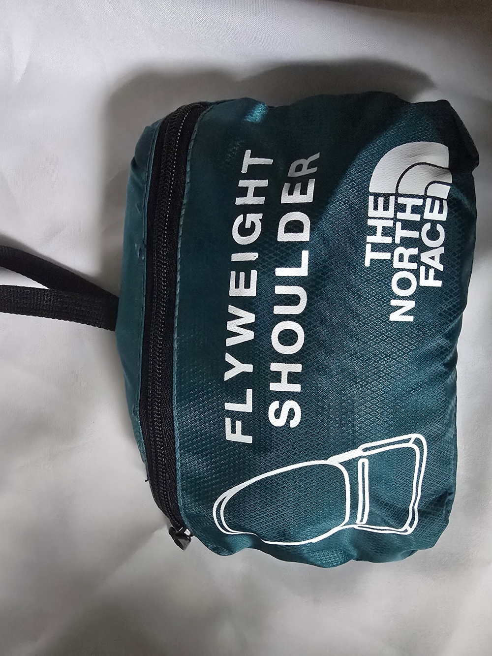 The North Face Flyweight Shoulder Pack in Teal Green